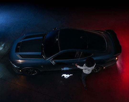 2024 Ford Mustang® Dark Horse™ model with a driver approaching the vehicle | Capitol Ford Santa Fe in Santa Fe NM