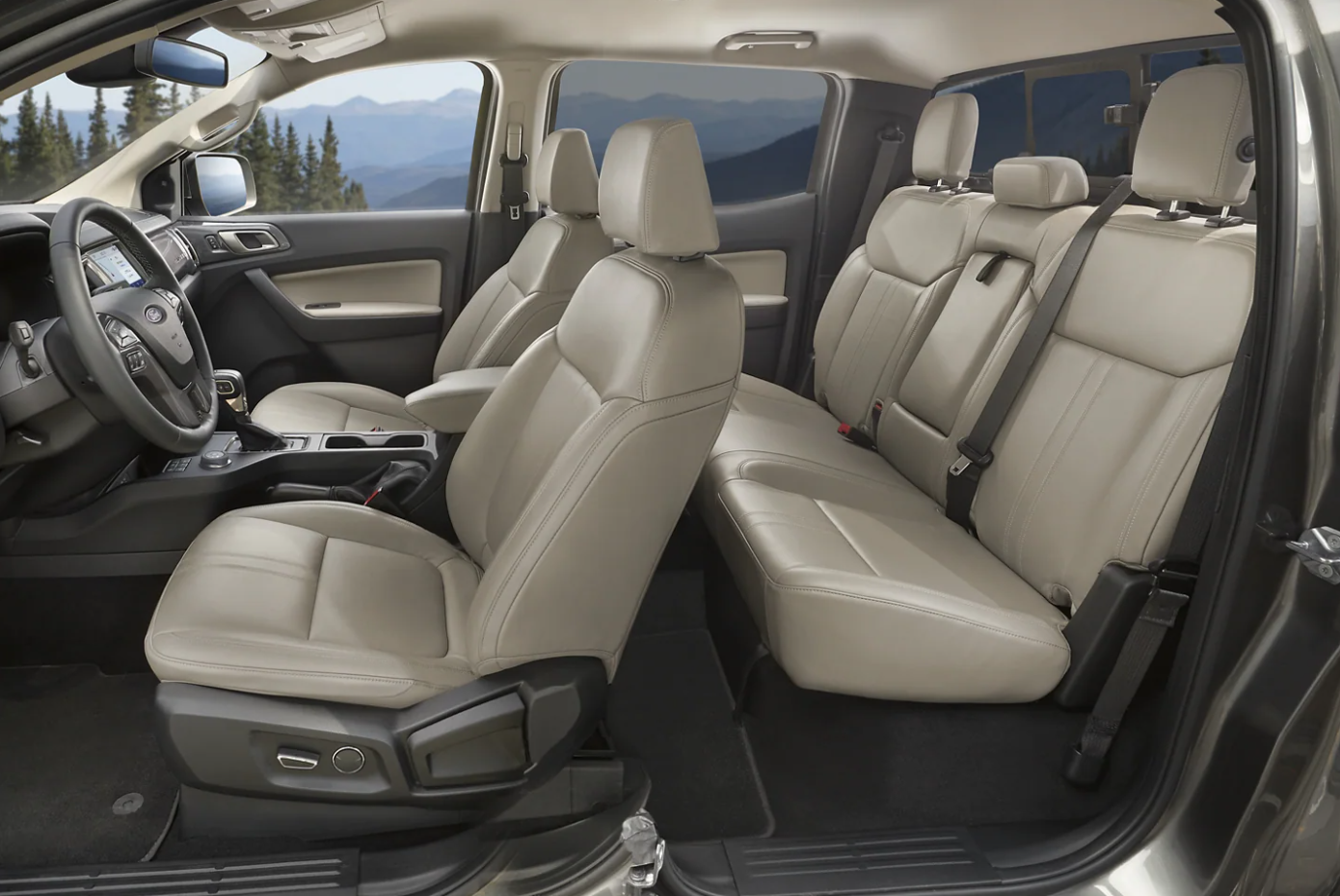 A side view of the full cabin of the 2022 Ford Ranger trimmed in cream leather and gray with a bench seat in back that can accomodate up to 3 people