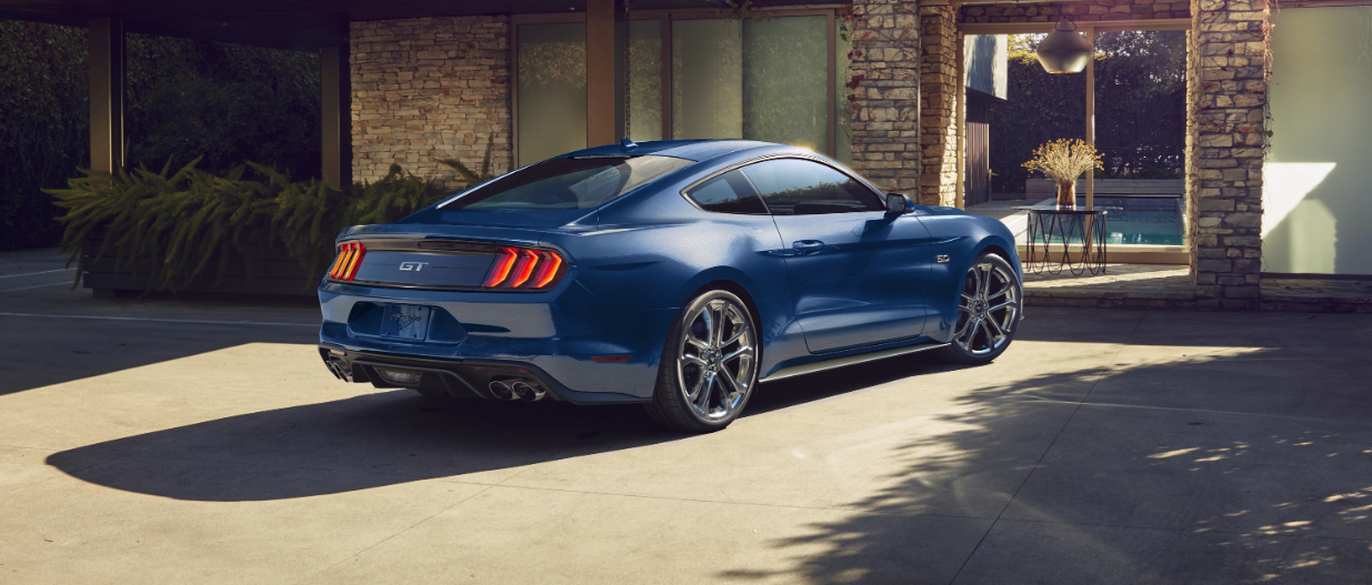 blue-mustang-parked-in-front-of-home