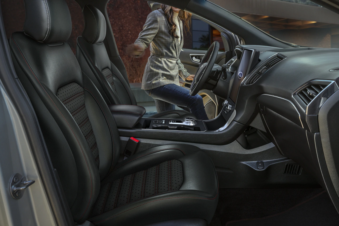 The interior cabin and seating upholstered in black leather in a 2023 Ford Edge